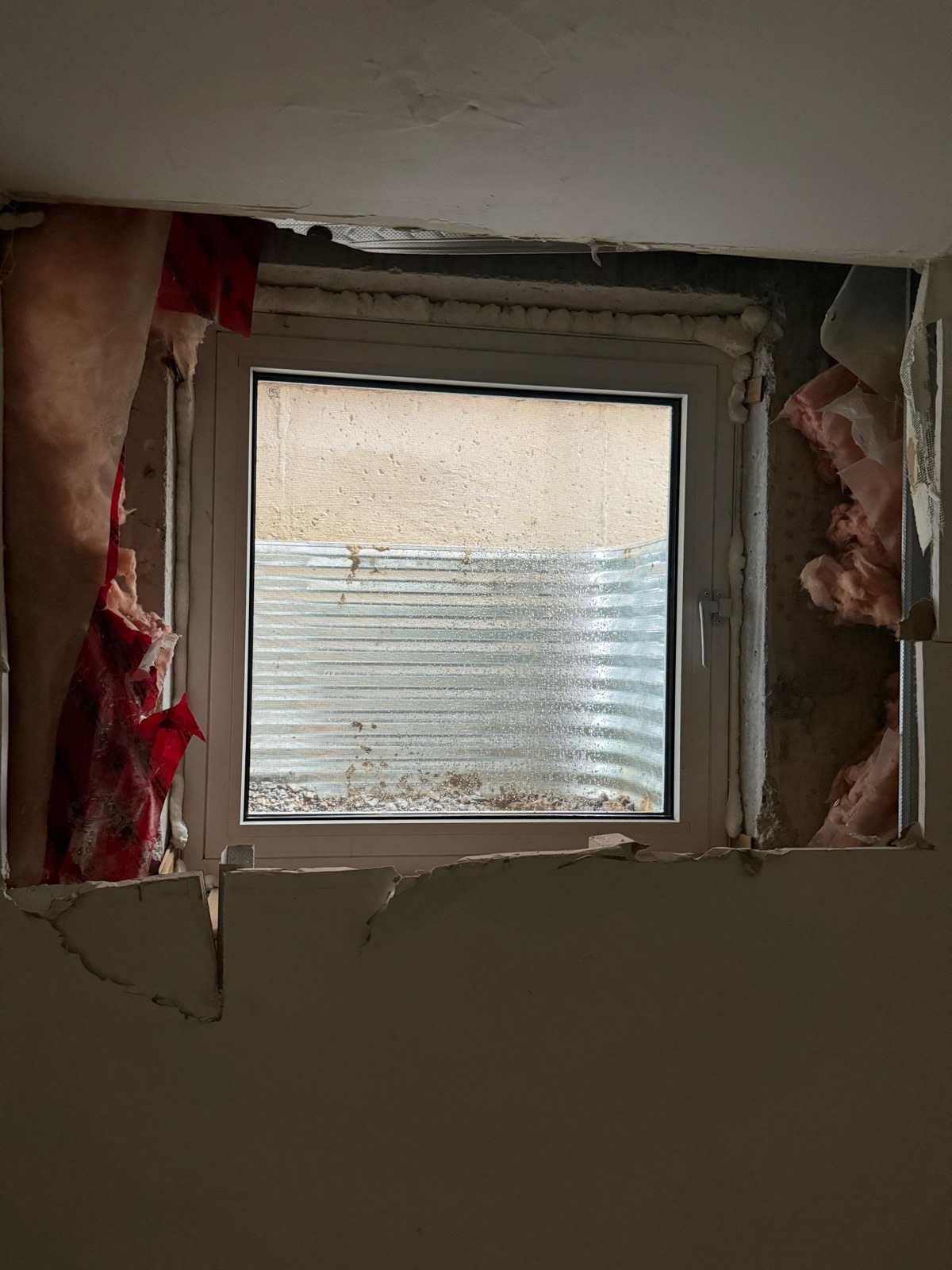 New basement window installed in an enlarged foundation opening