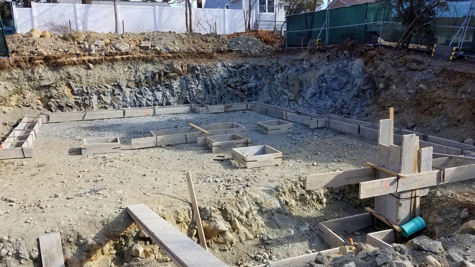 Wooden forms for concrete footings laid out in an excavated foundation